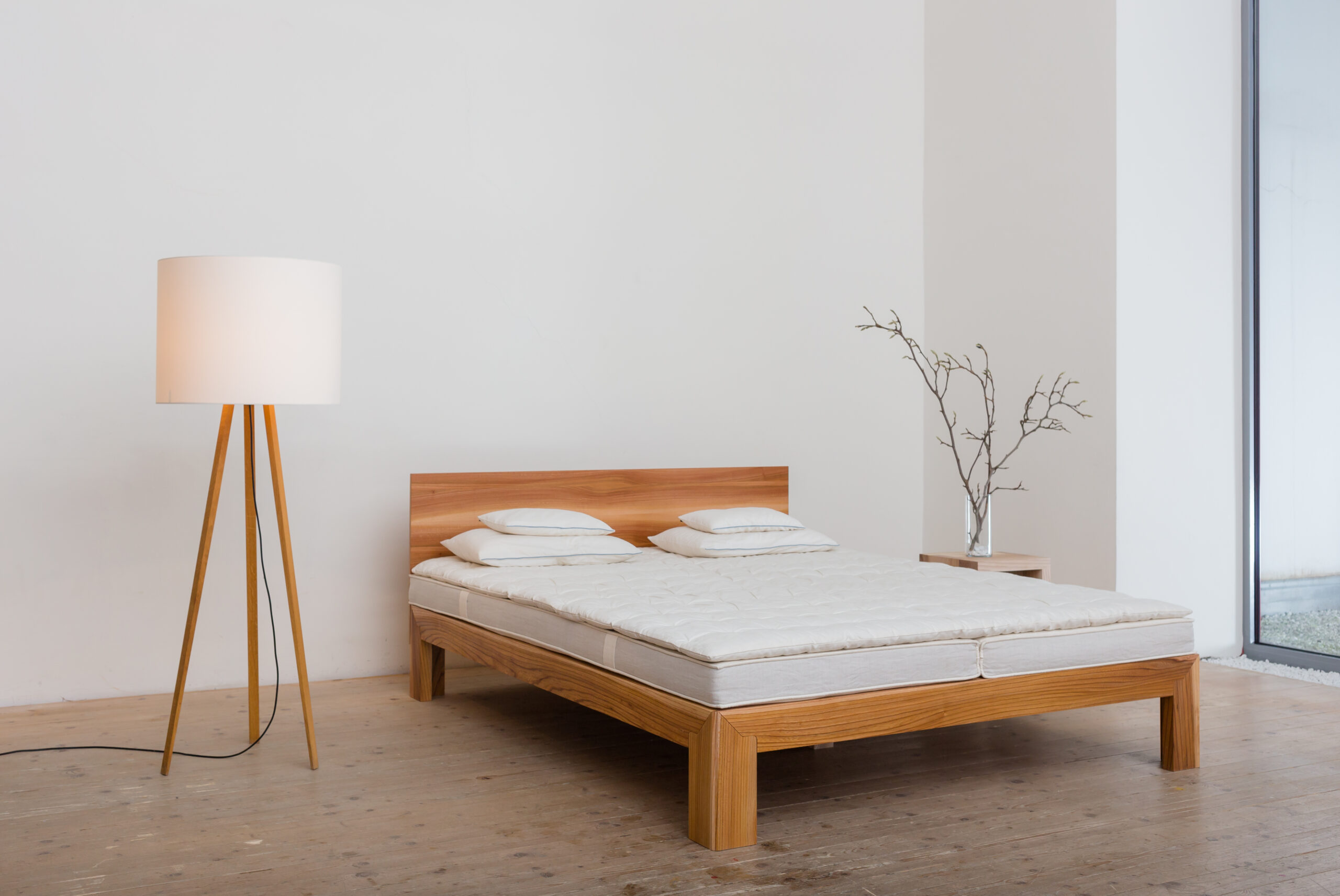 Das minimalistische Bett slimm neben einer Stehlampe